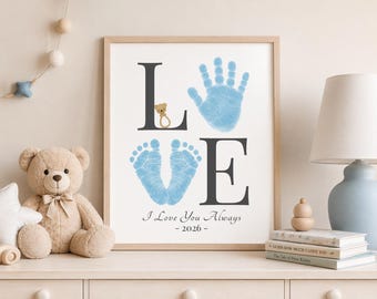 May include: Framed print with the word "LOVE" in black letters. The "L" has a teddy bear, the "O" is a blue handprint, the "V" is a blue footprint, and the "E" is a black letter. The text "I Love You Always - 2026" is below.