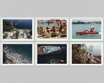 May include: A collection of six framed photographs depicting scenes of leisure and travel. Images include people on a beach, a red speedboat, a boat on the water, and a picnic overlooking the sea. The photographs have a vintage aesthetic.