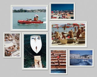May include: A collection of framed photographs depicting scenes of leisure and travel. Images include a red speedboat, people sunbathing on a beach, and a white boat docked at a wooden pier. The photographs are displayed against a gray background.