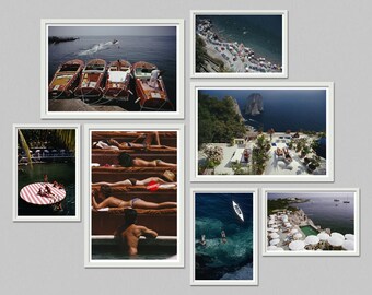 May include: A collection of framed photographs featuring scenes of boats, sunbathers, and coastal landscapes. The images showcase a variety of settings, including a harbor, a pool, and a beach with umbrellas.