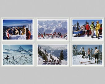 May include: Six framed vintage photographs depicting scenes of skiing and mountain landscapes. The images feature people in retro ski attire, snow-covered mountains, and outdoor gatherings. The photographs are in white frames.