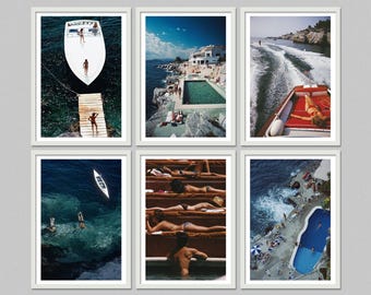 May include: Set of six framed art prints featuring coastal scenes. Images include a boat on the water, people sunbathing, a swimming pool, and a boat creating a wake. The prints are in white frames and are displayed against a gray background.