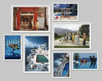 May include: A collection of framed vintage photographs. The images depict scenes of leisure, including people by pools, swimming, and a butcher shop. The color palette is vibrant, with blues, reds, and whites dominating the scenes.