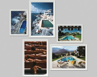 May include: Five framed vintage photographs featuring swimming pools and sunbathers. The images showcase pools near the ocean, in gardens, and with mountain backdrops. The frames are white, and the overall aesthetic is retro and evokes a sense of leisure.