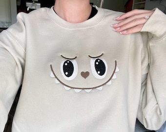 Cute Monster embroidered sweatshirt – Kawaii Creature Pullover – Spooky Cute Collectible-Inspired Unisex Crewneck