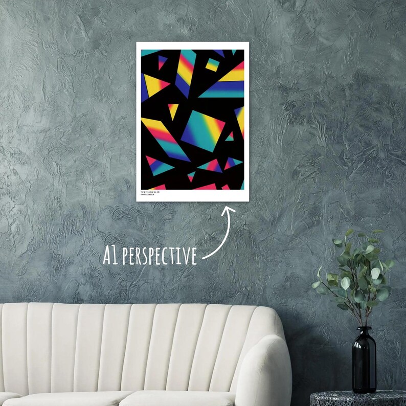 May include: A framed art print featuring a geometric design of colorful, overlapping shapes against a black background. The shapes include triangles and squares with gradients of yellow, blue, and pink. The print is displayed on a gray wall.