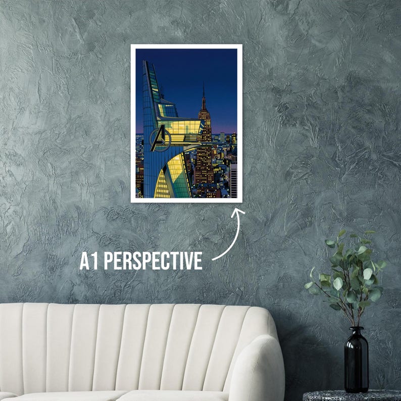 Op de afbeelding: Een ingelijste print met een gestileerde stadsgezicht bij zonsondergang. Het kunstwerk toont een moderne wolkenkrabber met het Avengers-logo en het Empire State Building. De tekst "A1 PERSPECTIVE" staat eronder.
