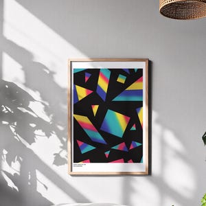 May include: Framed art print featuring a geometric design with colorful, gradient shapes on a black background. The artwork includes triangles and other angular forms in shades of yellow, blue, pink, and green. The print is in a wooden frame.