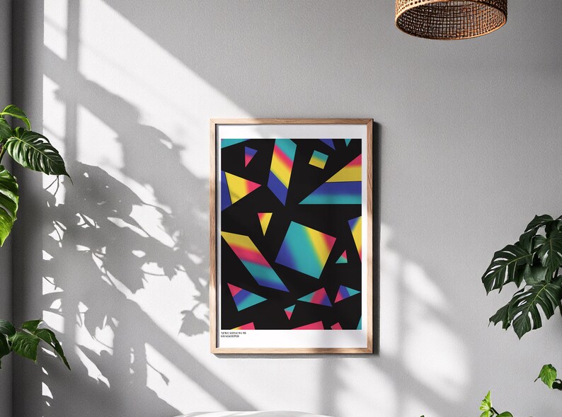 May include: Framed art print featuring a geometric design with colorful, gradient shapes on a black background. The artwork includes triangles and other angular forms in shades of yellow, blue, pink, and green. The print is in a wooden frame.