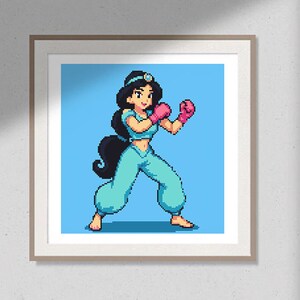 May include: Framed pixel art print of a cartoon character in a fighting stance. The character, with black hair and a blue outfit, wears pink boxing gloves. The background is light blue, and the frame is a light brown color.