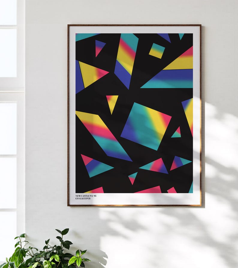 May include: Framed art print featuring a geometric design with colorful, abstract shapes against a black background. The shapes include triangles, squares, and other irregular forms in shades of yellow, pink, blue, and green. Text at the bottom reads "NEWCASTLE 94-95 GOALKEEPER."