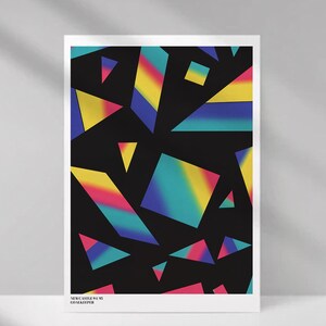 May include: A framed art print featuring a black background with colorful geometric shapes in shades of yellow, pink, blue, and green. The text "NEWCASTLE 91-92 GOALKEEPER" is printed at the bottom.