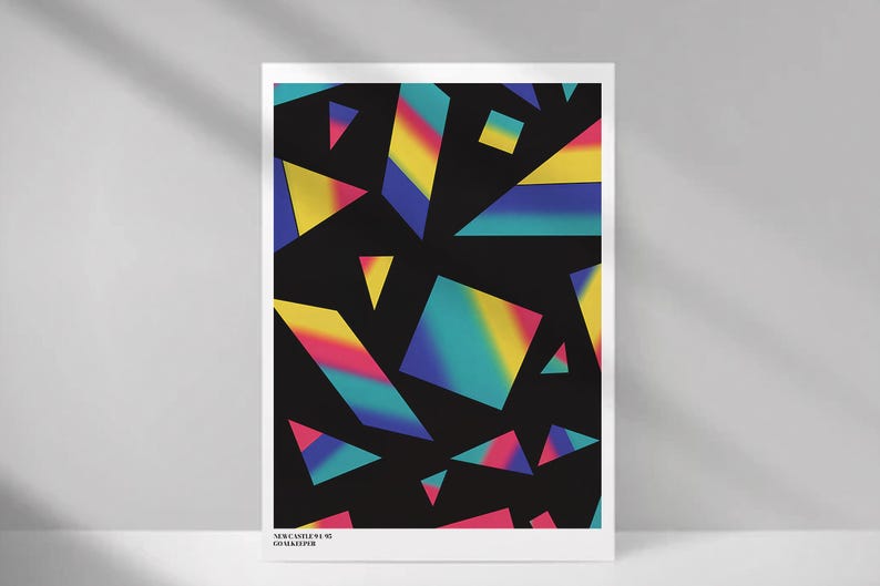 May include: A framed art print featuring a black background with colorful geometric shapes in shades of yellow, pink, blue, and green. The text "NEWCASTLE 91-92 GOALKEEPER" is printed at the bottom.