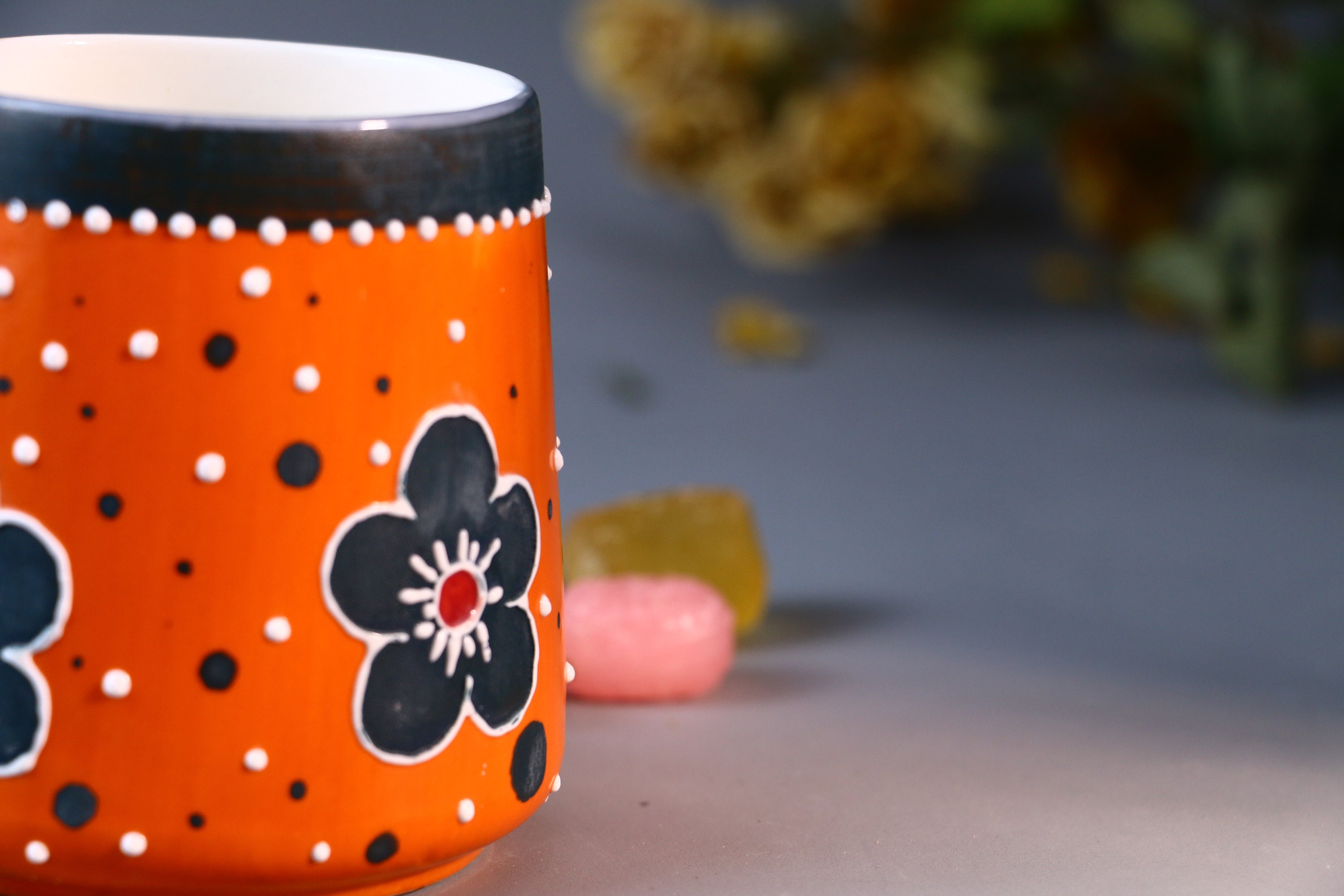 大胆なオレンジ色の陶器マグカップ - 手描きの花と水玉模様のデザイン