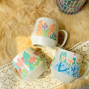 Artisan mug featuring a hand-painted floral design.