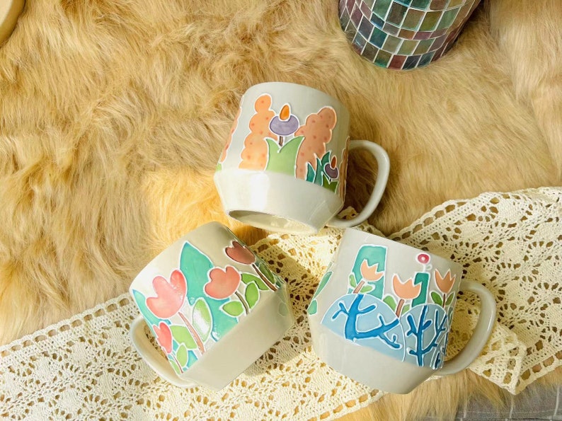 Artisan mug featuring a hand-painted floral design.