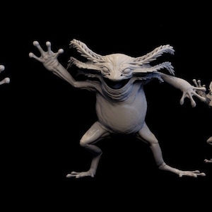 Peut inclure: Cinq créatures miniatures ressemblant à des grenouilles, grises, de 35 mm de haut, avec de multiples bras et jambes. Les créatures sont posées dans différentes positions dynamiques. Le texte "Mini Monster Master Vol 2" est visible dans le coin supérieur gauche de l'image. Le texte "35mm tall - 25 base" est visible dans le coin supérieur droit de l'image.