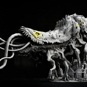 May include: A detailed, gray, 3D printed model of a monstrous creature with multiple legs, a long, curled tail, and glowing yellow eyes. The creature is standing on a base with a small, detailed cityscape. The text "NIGHTMARE FUEL" is printed below the creature.