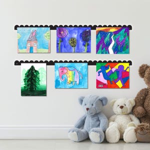 Wall mounted scalloped metal kids art display board with two rails holding six colorful kids drawings using pushpin-style magnets. Handmade in the USA, this kids artwork display is perfect for showcasing creativity in a nursery, homeschool, or play space. Ideal as a kids magnet board, kids drawing display, or playroom decor sign. A functional and charming artwork display sign for playroom wall art or kids room decor that celebrates children’s imagination and expression.