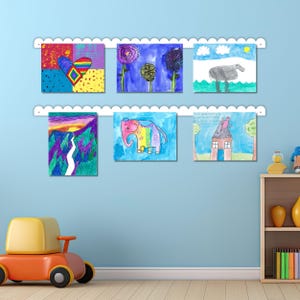White scalloped metal wall mounted kids art display board with two rails holding six vibrant children’s drawings using colorful magnets. This kids magnet board is handmade in the USA and perfect for use as a kids art display, kids drawing display, or artwork display sign. A charming addition to kids room decor, playroom wall art, or classroom spaces. This playroom decor sign celebrates creativity and makes an ideal look what we made or look what I made art display.