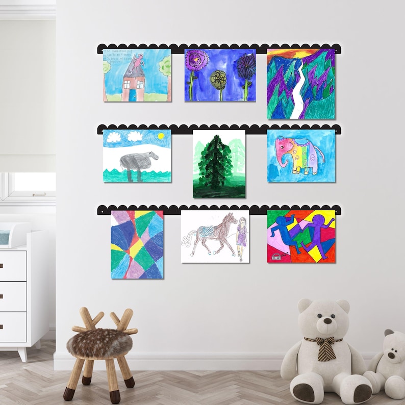 Metal wall mounted kids art display with scalloped edges showcasing nine colorful drawings using magnets. This handmade in USA kids artwork display functions as a kids magnet board and kids drawing display. Perfect for playroom wall art, kids room decor, or classroom use. A charming art display board and artwork display sign that keeps kids' creativity organized. Ideal as a playroom decor sign or look what we made art display for proud parents and grandparents.