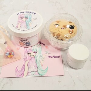 May include: A pink and green slime jar with a cartoon girl on the label. The jar is labeled "Mochi Fun Slime". The slime is packaged with a cookie, a small jar of slime, and a pink card with a cartoon girl on it. The card says "All the time!"