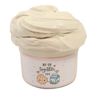 May include: A white slime in a clear jar with a pink and white label that says "We go together like" with a cartoon cookie and milk carton holding hands.