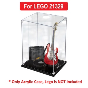 May include: Clear acrylic display case for LEGO 21329, a red electric guitar, amplifier, and guitar strap.  *Only Acrylic Case, Lego is NOT Included*