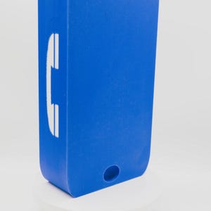 May include: A rectangular blue wall-mounted object with rounded corners. The front face features a white telephone handset icon on the left side. There is a keyhole-shaped mounting slot at the top and a circular hole at the bottom center.