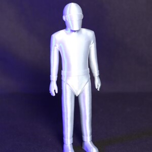 May include: A white plastic action figure of a robot wearing a helmet with a visor. The figure is standing with its arms at its sides.