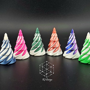 May include: A collection of six colorful, spiral-designed Christmas tree ornaments. Each tree features a unique color combination, including blue and white, pink and white, green and white, orange and white, purple and white, and green and white. The base of each tree is white.
