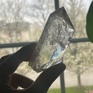 Large 2 bubble enhydro quartz point with small moving black sand pocket