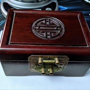 Beautiful dark wood jewelry/trinket box with blue satin inside