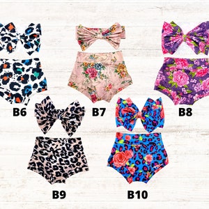 Puede incluir: Cinco conjuntos de cubrepa&ntilde;ales para beb&eacute; con lazos a juego, etiquetados del B6 al B10. Los dise&ntilde;os incluyen estampado de leopardo en blanco y negro con toques naranjas y azules, flores rosas, flores moradas, leopardo beige y leopardo azul.