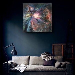 May include: A painting of a nebula in shades of pink, blue, and purple. The nebula is a swirling cloud of gas and dust, with a bright star in the center.