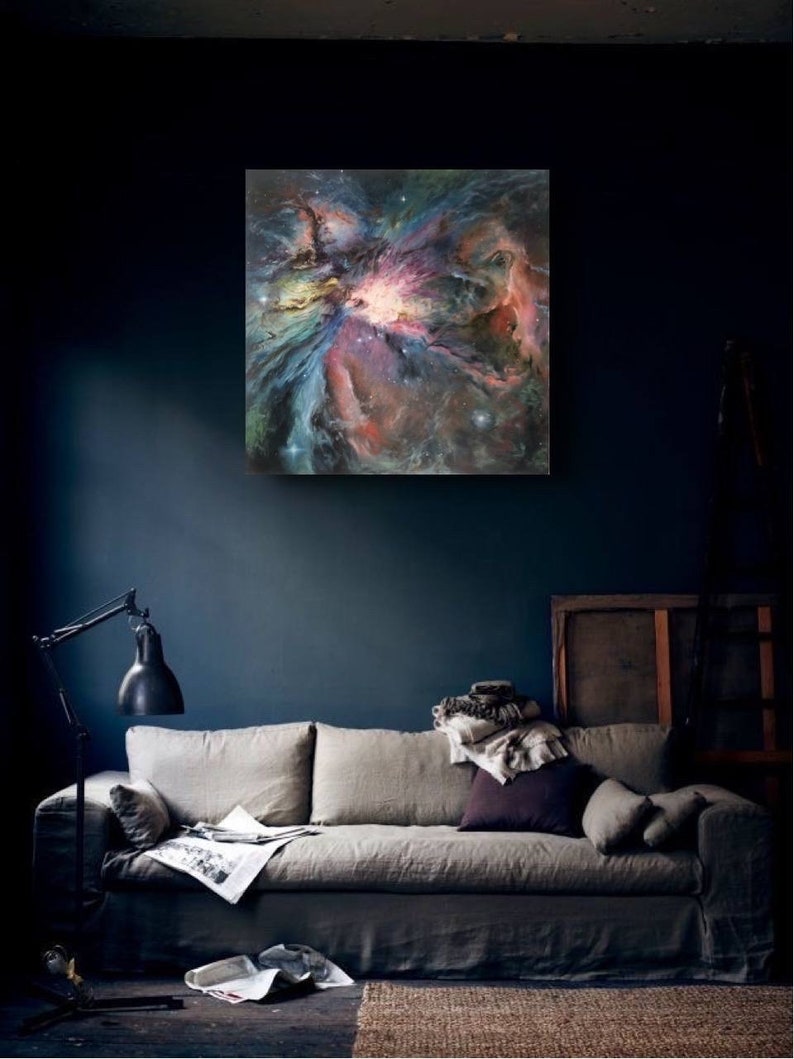 May include: A painting of a nebula in shades of pink, blue, and purple. The nebula is a swirling cloud of gas and dust, with a bright star in the center.