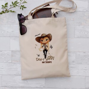 Tote Bag with Cowboy Girl Cartoon Illustration and Quote "Don't Worry Be Happy" - Cute and Inspirational Tote, Perfect Gift for Girls
