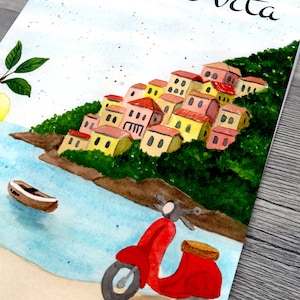 May include: Watercolor painting of a coastal Italian village with colorful buildings and a red scooter. The phrase "la dolce vita" is written in cursive at the top. A boat floats in the blue water.