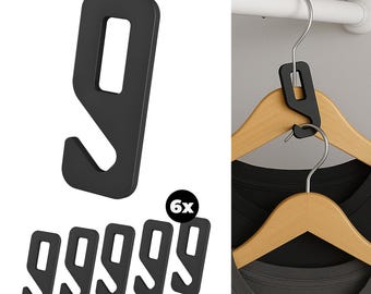 May include: Black plastic hanger connectors. The image shows six connectors, with one detached and the others attached to wooden hangers holding shirts. The connectors are designed to link multiple hangers together, maximizing closet space.