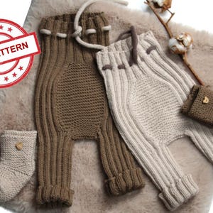 Puede incluir: Dos pares de pantalones de punto para bebé, uno marrón y otro beige, con botines de punto a juego. Los pantalones tienen cintura con cordón y los botines tienen un pequeño botón de madera.