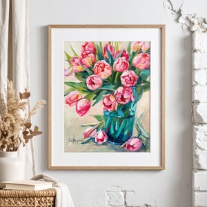 A framed artwork of a bouquet of pink tulips in a green glass vase