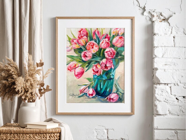 A framed artwork of a bouquet of pink tulips in a green glass vase