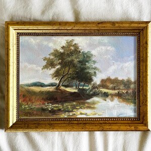 Vintage french landscape art print with blue sky, river, and trees, framed in gold, classical wall decor