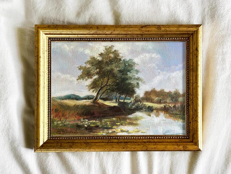 Vintage french landscape art print with blue sky, river, and trees, framed in gold, classical wall decor
