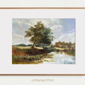 French landscape art print - created in vintage style. The print features the blue cloudy sky, river, and trees, framed in gold frame with wide white mat.