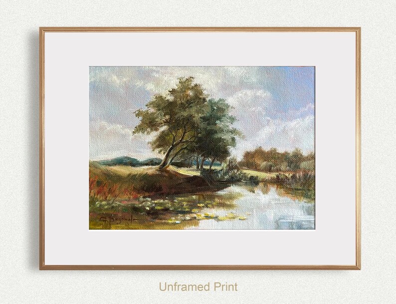 French landscape art print - created in vintage style. The print features the blue cloudy sky, river, and trees, framed in gold frame with wide white mat.