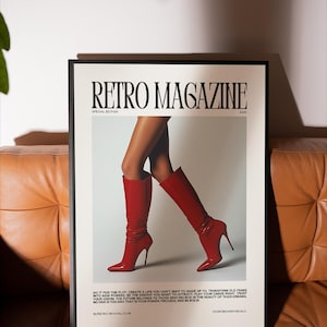 May include: A framed poster with the text "RETRO MAGAZINE" and the words "SPECIAL EDITION 2025". The poster features a pair of legs wearing red high-heeled boots. The poster is on a brown leather couch.