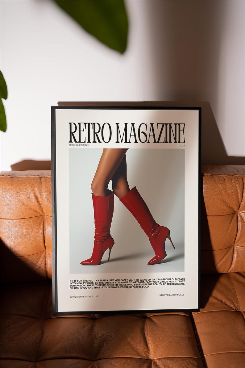 May include: A framed poster with the text "RETRO MAGAZINE" and the words "SPECIAL EDITION 2025". The poster features a pair of legs wearing red high-heeled boots. The poster is on a brown leather couch.