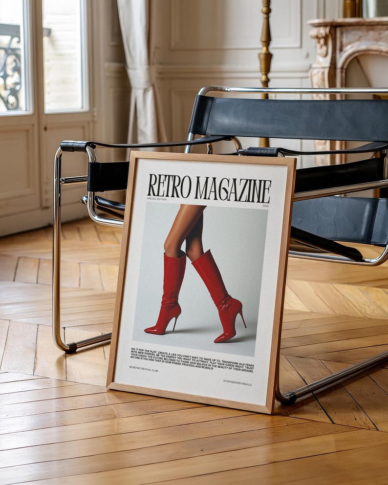 May include: A framed "Retro Magazine" print featuring a pair of legs in red high-heeled boots. The print has a wooden frame and is displayed on a wooden floor. The text on the print includes the magazine title and other text.