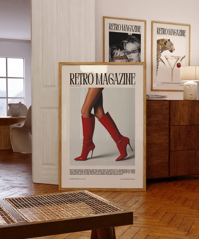 May include: A framed "Retro Magazine" poster featuring a woman's legs in red high-heeled boots. The poster is in a wooden frame and is displayed with two other framed posters. The text "Retro Magazine" is visible.